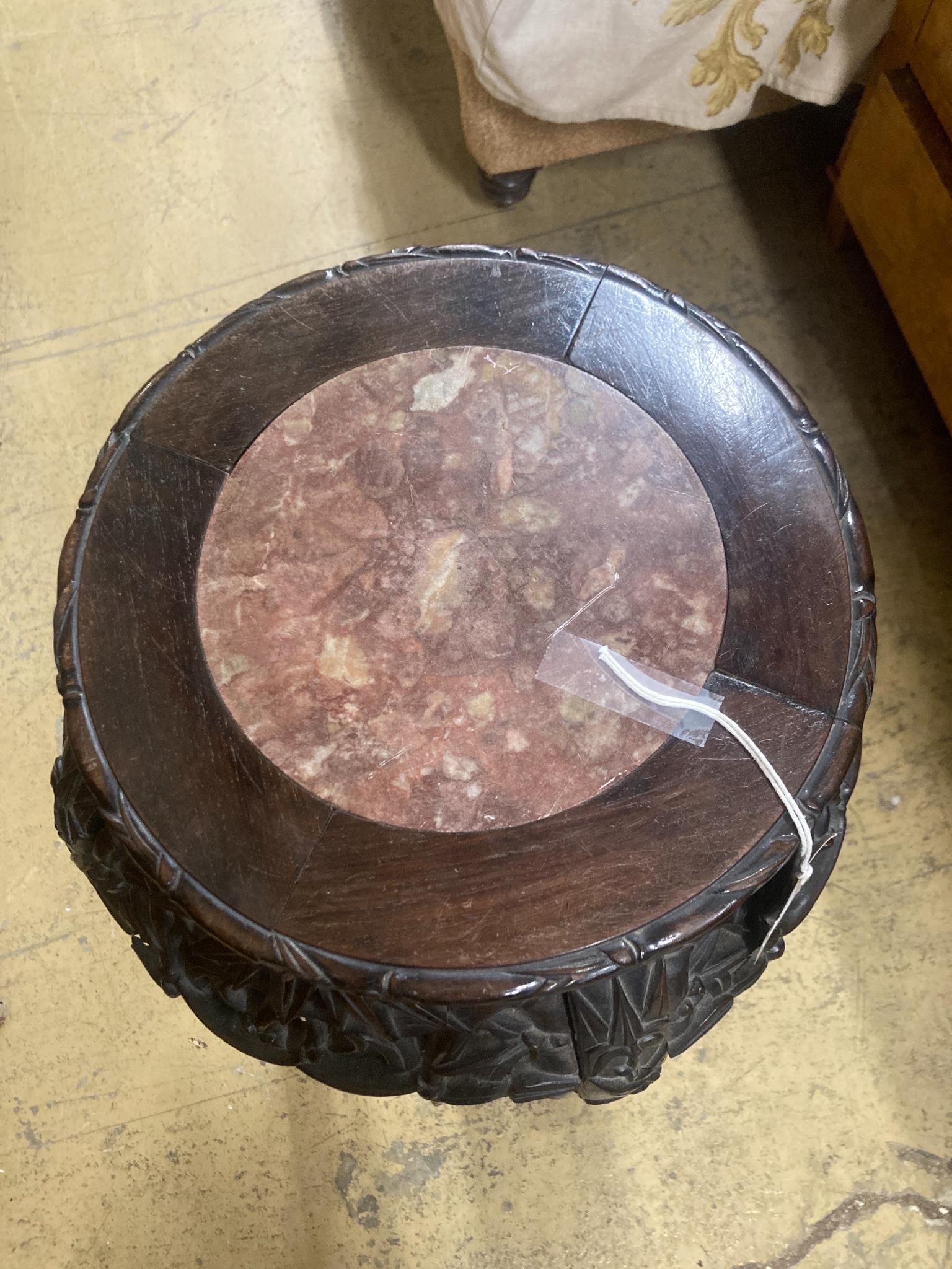 A Chinese carved hardwood marble top vase stand